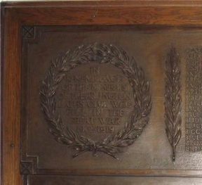 Photo of the War Memorial, an iron plaque with names of people who served in both world wars