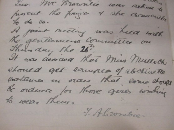 Handwritten extract from the ladies minute book saying "“It was decided that Miss Malloch should get samples of stockinette costumes in order that some should be ordered for those wishing to wear them.”