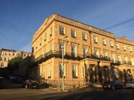 Photo of a very large Victorian mansion built in blond sandstone on the corner of a street