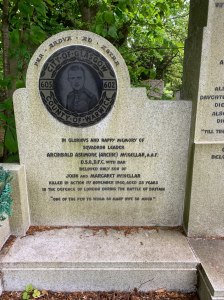 Memorial to Archibald McKellar on the family gravestone. It has a portrait of him, the words 'Per ardva ad astra' and 'In glorious and happy memory of Squadron leader Archibald Ashmore ( arhcibe) Mckellar RAF, DSO, DFC with bar. Beloved only son of John and Margret McKellar. Killed in action 1st November 1940, aged 28 years, In the defence of London during the Battle of Britain. "One of the few to whom so many owe so much"'