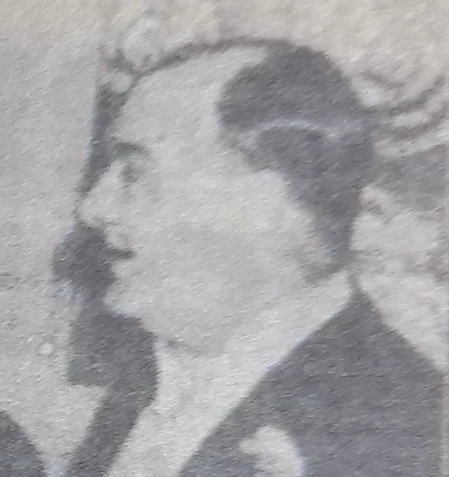 Newspaper photo of the head in profile of man in evening dress
