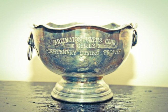 A small silver bowl with small rings on each side engraved with eh words ' Arlington Batsh Club Girls Centenary Diving Trophy'